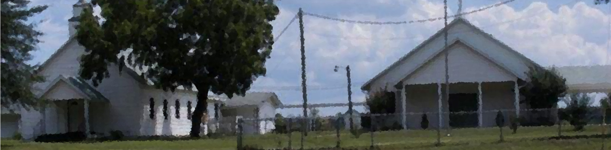 Oak Grove Baptist Church building with oak tree and grass
